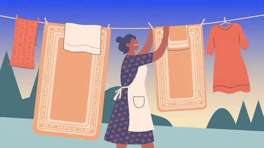 a woman hanging a bath rug and mat outside to dry. The bath rug and mat are placed over a clotheslin