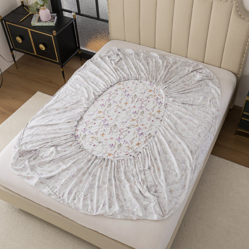 Floral-patterned mattress cover on a bed in a bedroom setting