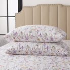 Floral-patterned pillows on a bed with a beige headboard