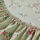 Floral-patterned mattress cover on a bed in a bedroom setting