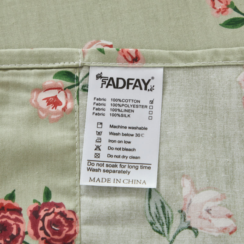 Fabric label with care instructions on a red floral patterned fabric