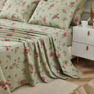 Bed with red floral patterned bedding in a bedroom setting