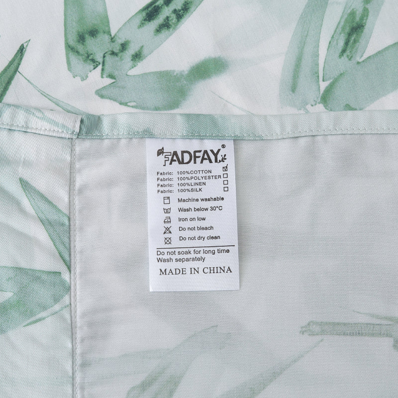 Fabric label with care instructions on a green leaf patterned fabric