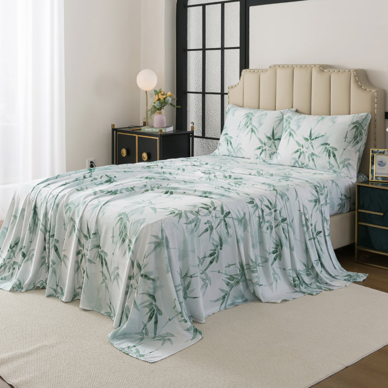 Bed with green leaf patterned bedding in a bedroom setting