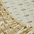 Floral-patterned mattress cover on a bed in a bedroom setting