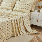 Bed with red rose patterned bedding in a bedroom setting