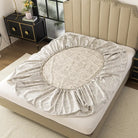 Floral-patterned mattress cover on a bed in a bedroom setting