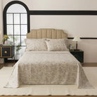 Bed with red floral patterned bedding in a bedroom setting.