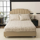 Bed with red floral patterned bedding in a bedroom setting.