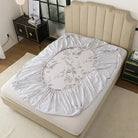 Floral-patterned mattress cover on a bed in a bedroom setting