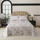 Bed with red floral patterned bedding in a bedroom setting.