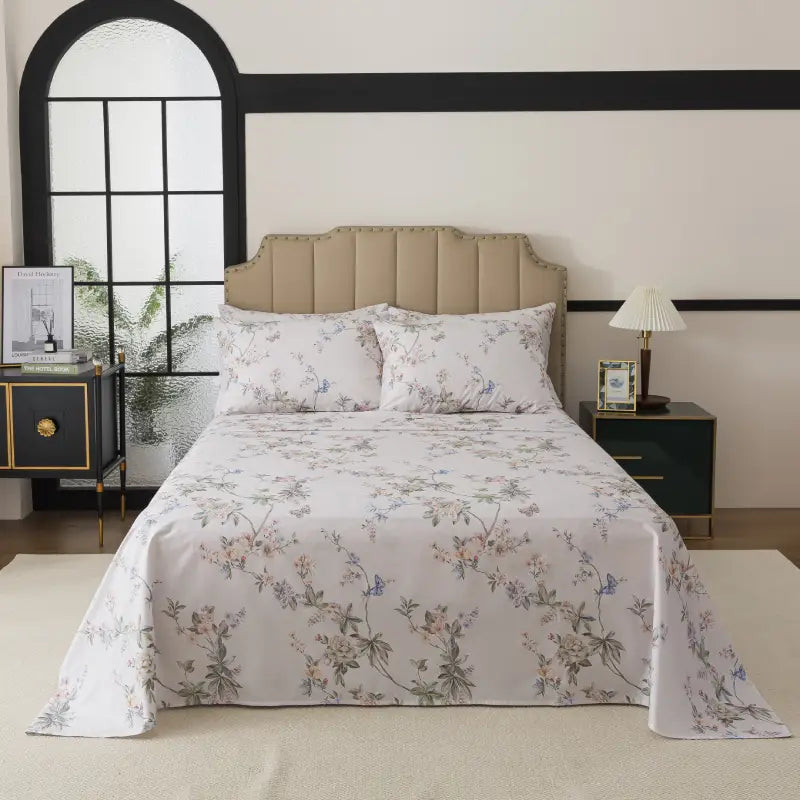 Bed with red floral patterned bedding in a bedroom setting.
