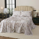 Bed with red floral patterned bedding in a bedroom setting