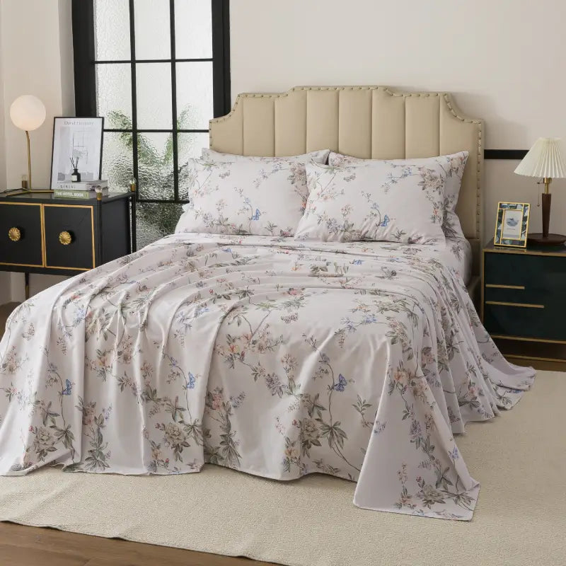 Bed with red floral patterned bedding in a bedroom setting