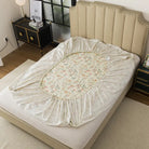 Floral-patterned mattress cover on a bed in a bedroom setting