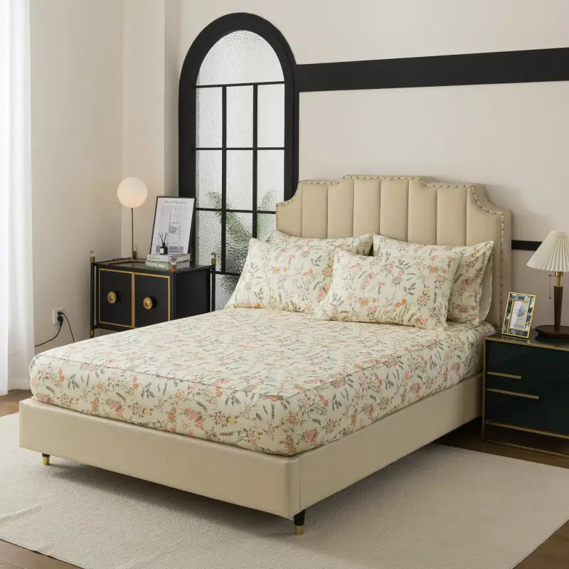 Bed with red floral patterned bedding in a bedroom setting